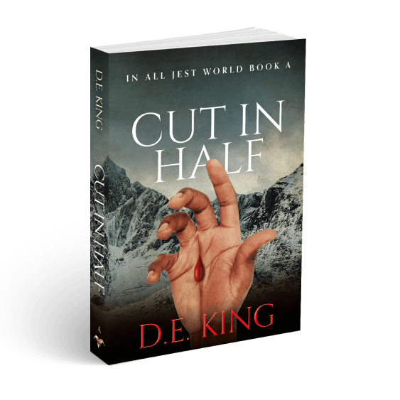3D book cover of Cut in Half by D.E. King, featuring a severed hand with a bleeding finger against a snowy mountain backdrop.