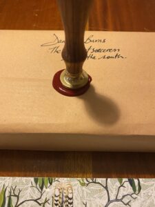 Sealing the signed paperback with wax