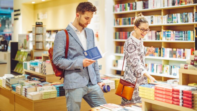 Two people browsing books in a bookstore